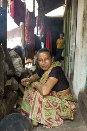 A woman working around the house in a home off of Hindu Street